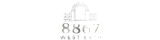 Elegant logo for 8867 West 54th Apartments featuring a stylized archway design, exuding modern sophistication.