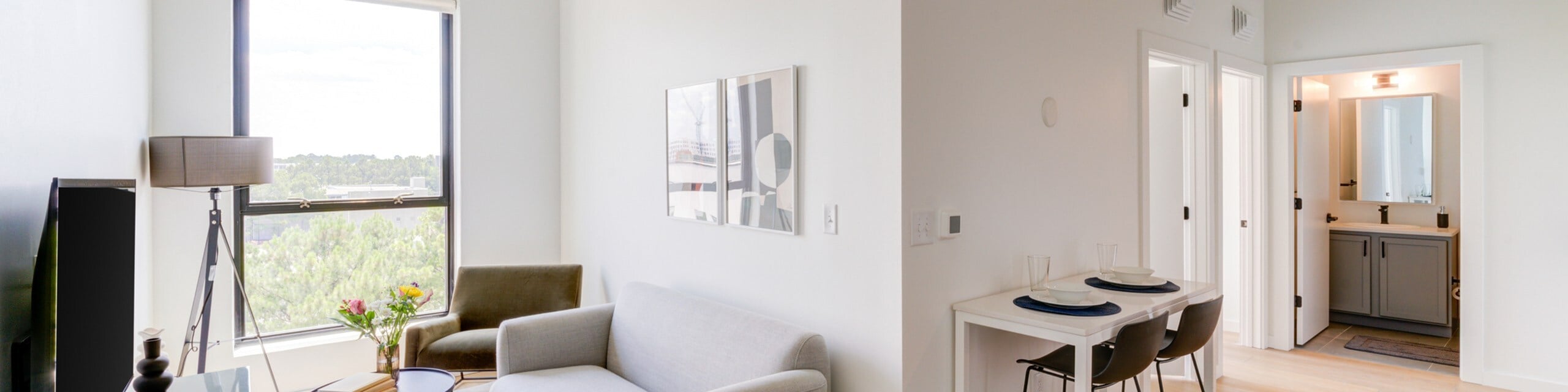 2 Bedroom Coliving living room with dining room and bathroom vanity
