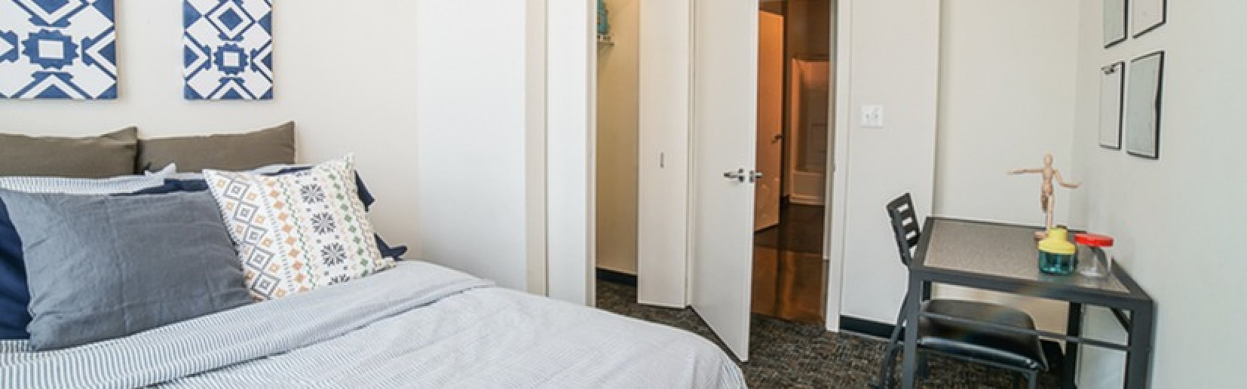 Bright and stylish bedroom featuring modern decor, comfortable bedding, and cozy workspace.