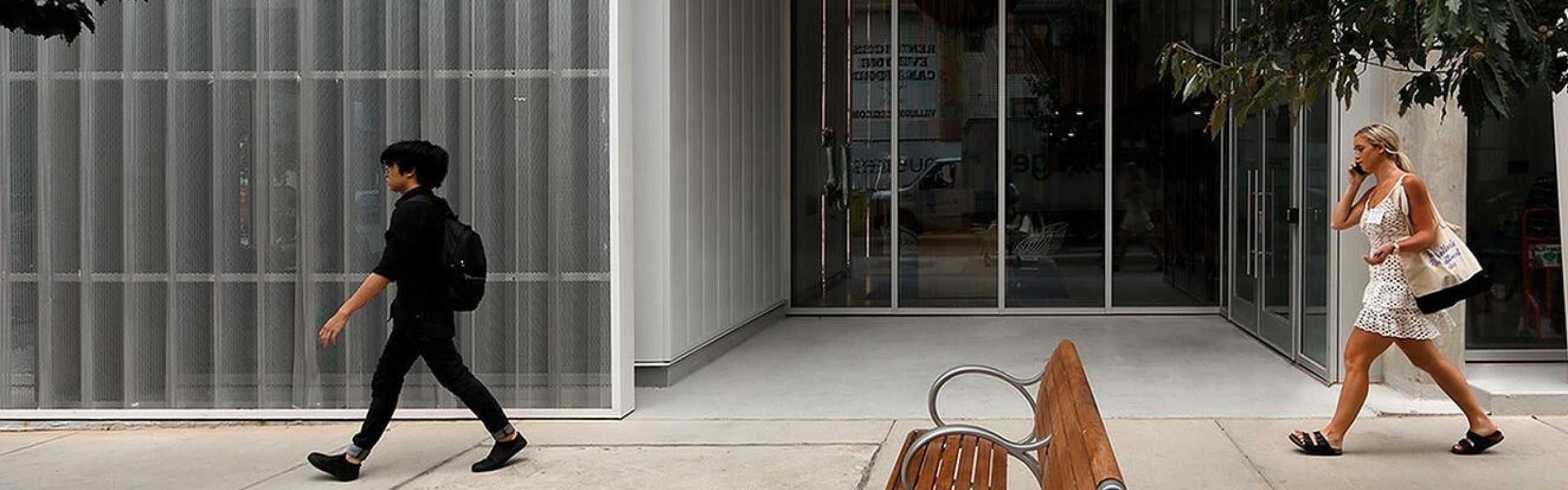 Modern entrance of Inspire on 22nd, featuring sleek architecture and inviting urban environment.
