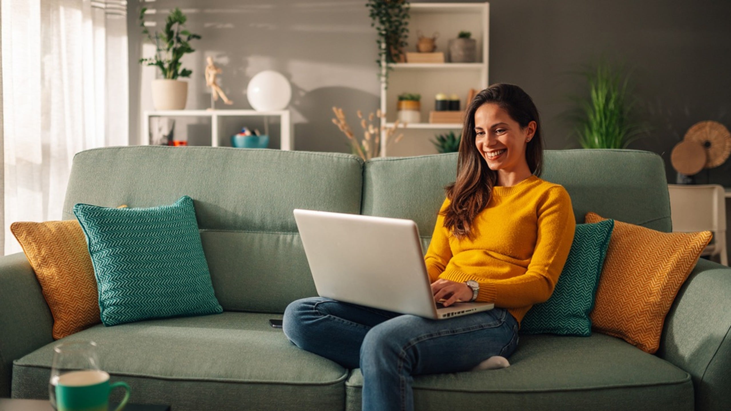 Woman sitting on couch with computer