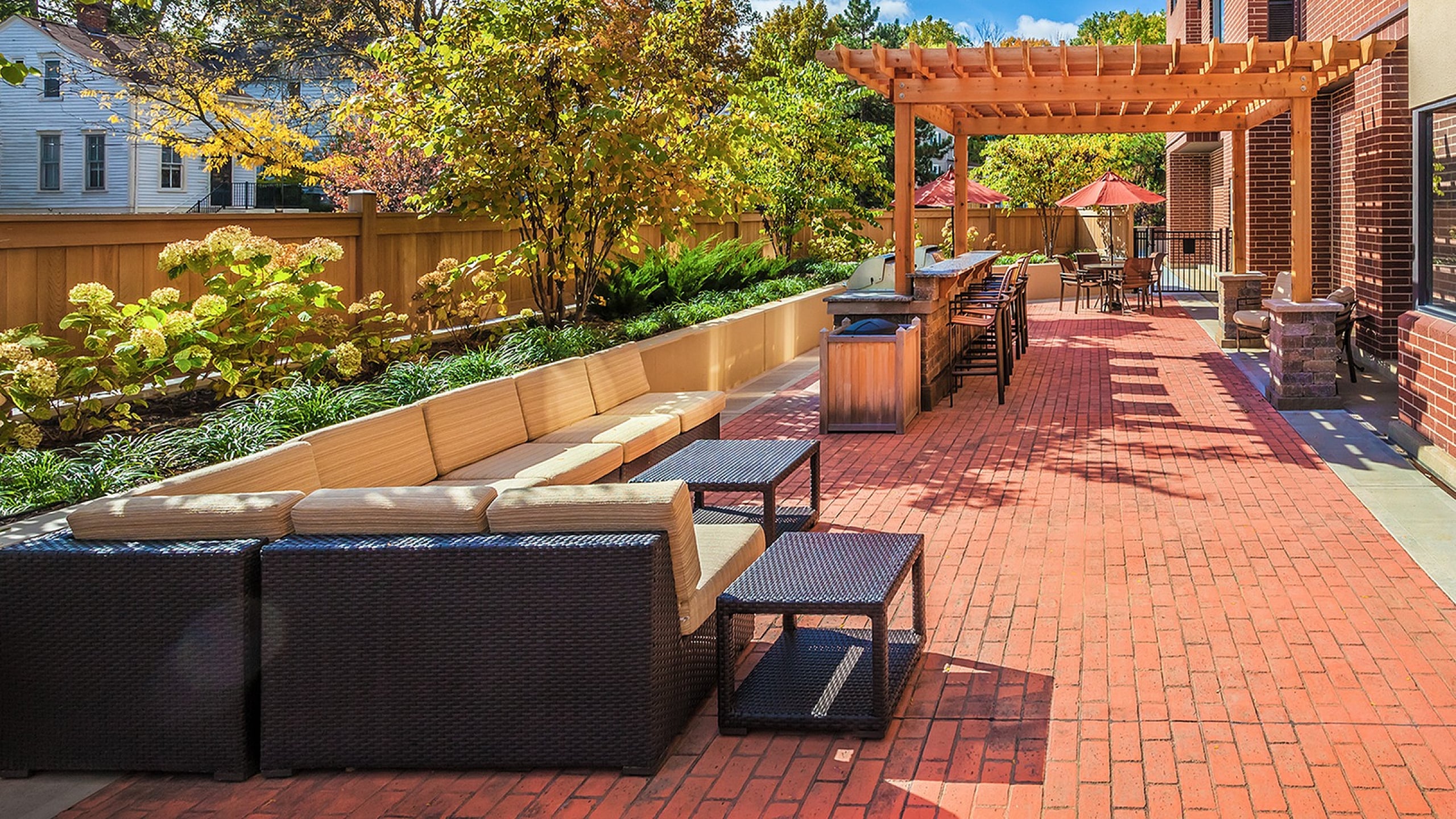 Charming outdoor patio with elegant seating, vibrant garden, and stylish pergola for perfect outdoor relaxation.