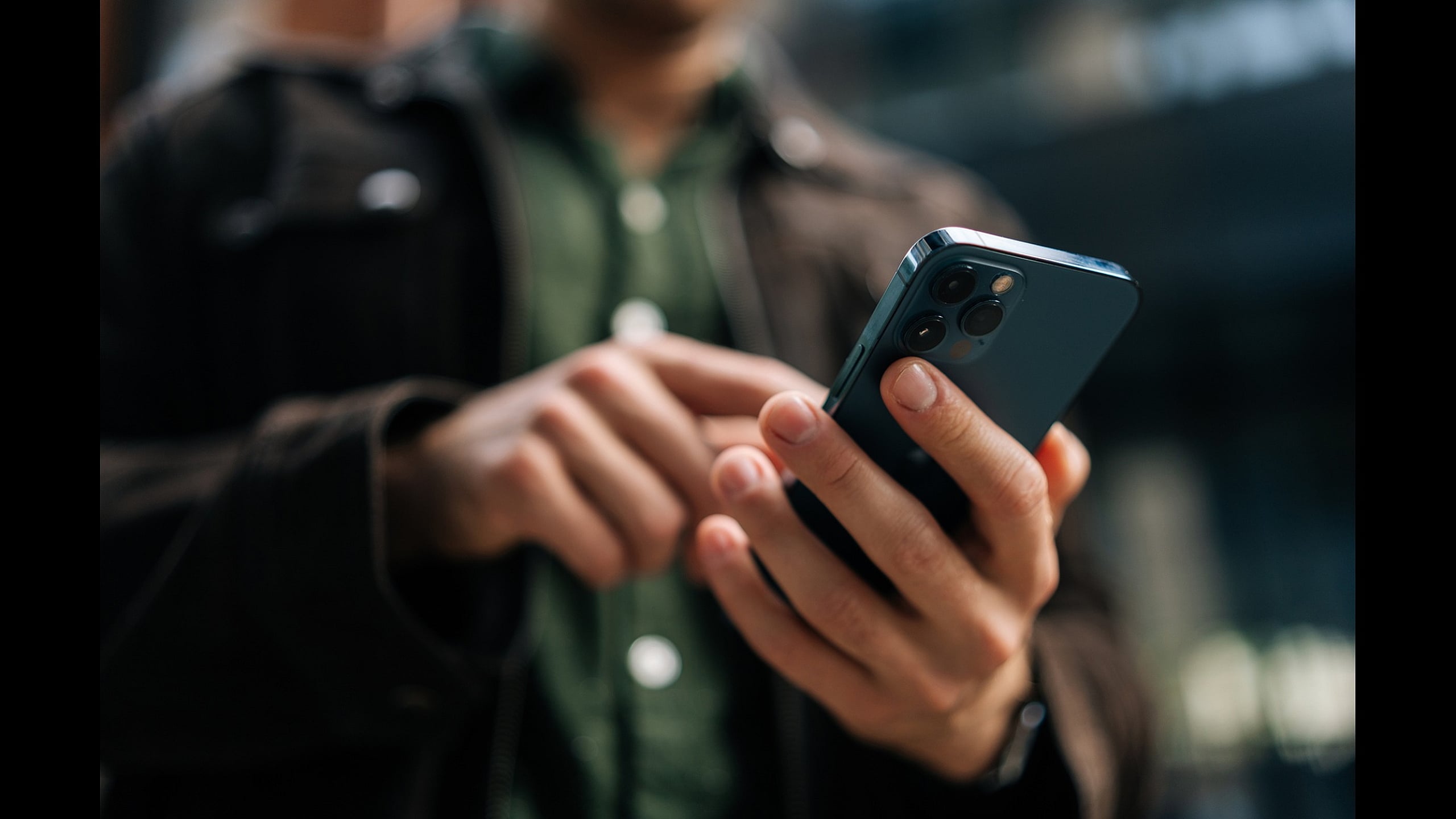 Close-up of a person holding a modern smartphone, showcasing sleek design and advanced camera features.