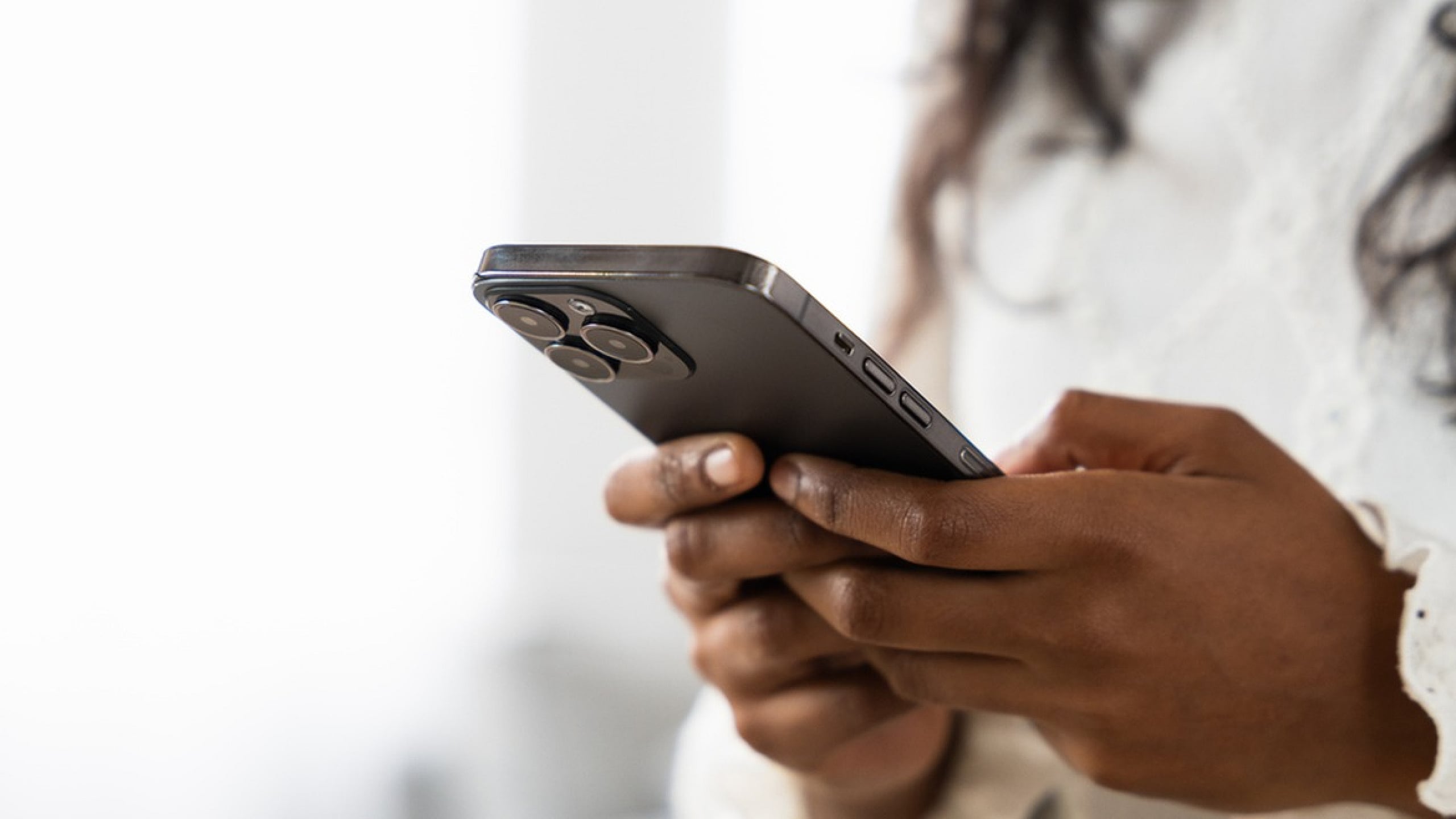 Close-up of a stylish smartphone in elegant hands, highlighting modern technology and sleek design.