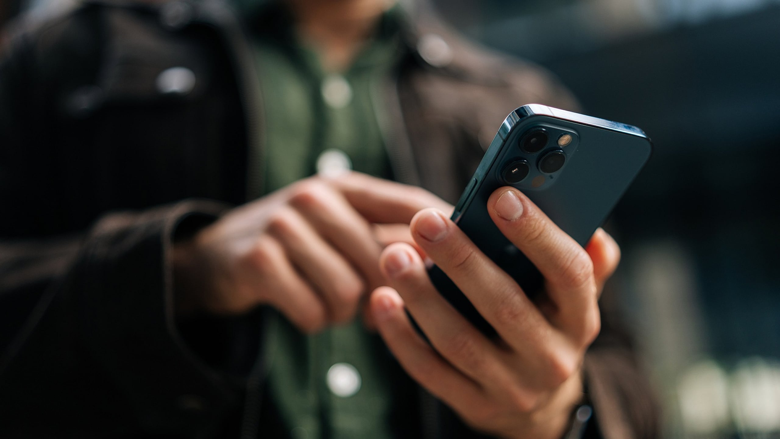 Close-up of a person using a modern smartphone, highlighting sleek design and advanced technology.