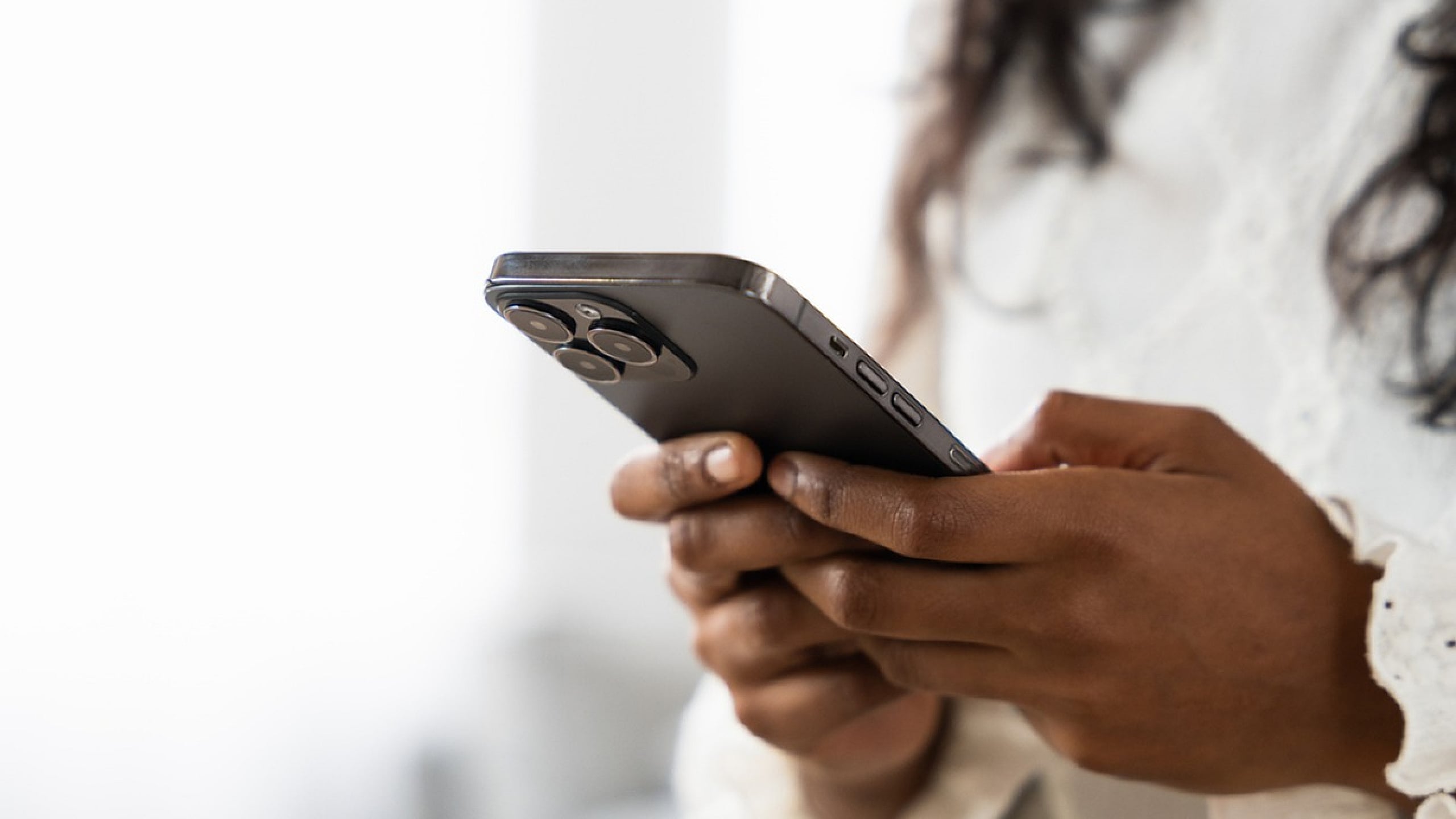 Close-up of a person using a sleek smartphone, highlighting modern technology and connectivity.