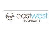 East West Hospitality logo featuring compass design and modern typography.