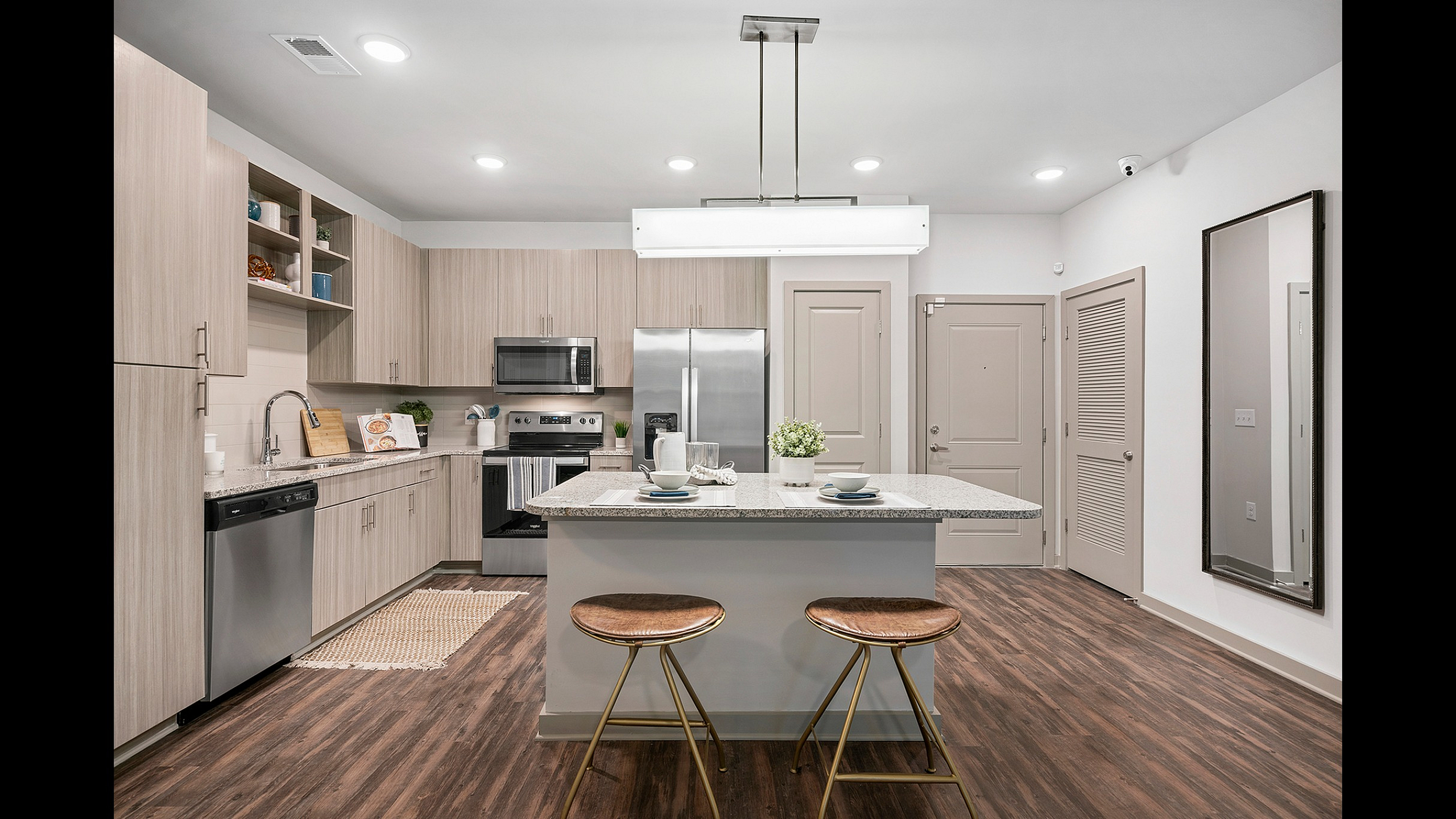 Modern kitchen with sleek cabinets, granite countertops, and stylish island seating, perfect for culinary enthusiasts.