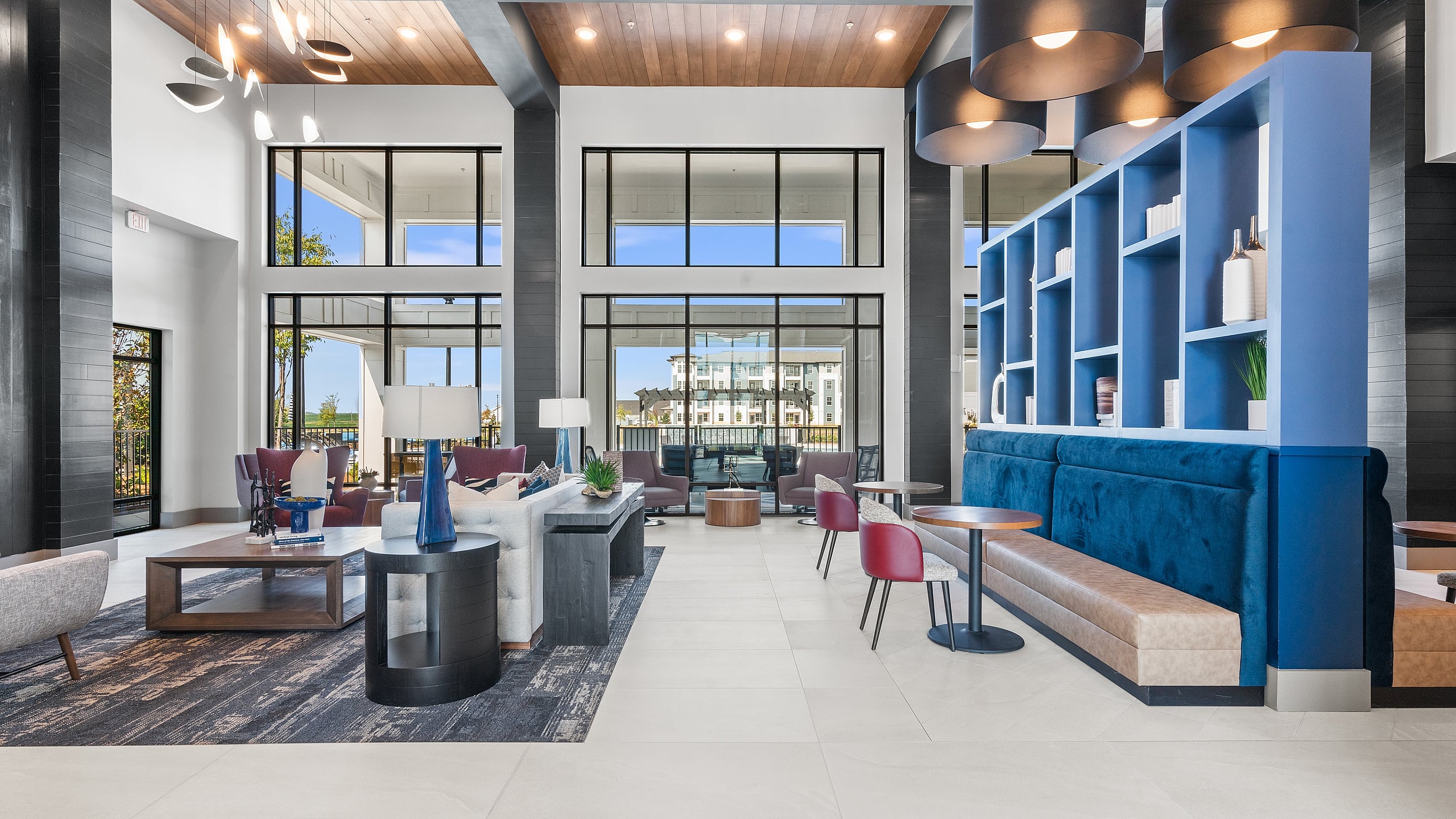 Luxurious and modern lounge with stylish seating, elegant lighting, and expansive windows providing scenic views.