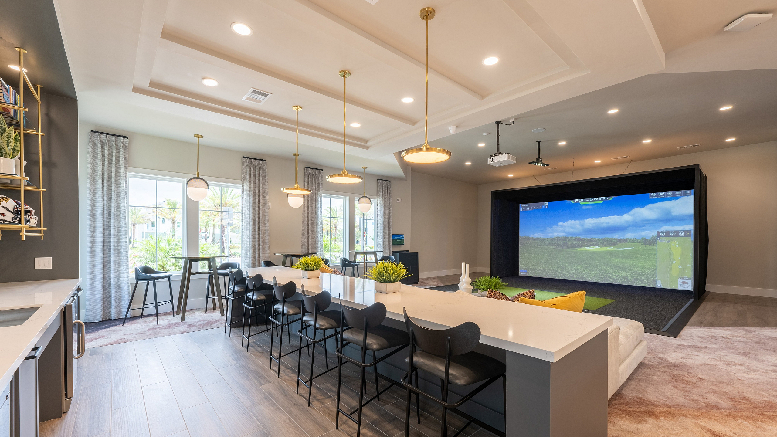 Luxurious entertainment room with a long sleek bar, plush seating, and an advanced golf simulator, highlighted by modern lighting and large windows.