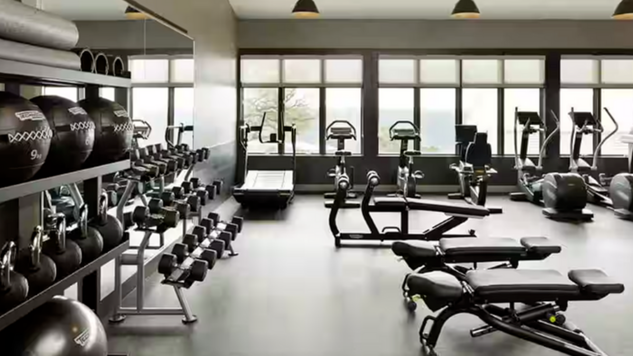 Modern fitness center with state-of-the-art equipment and natural lighting, perfect for energizing workouts.
