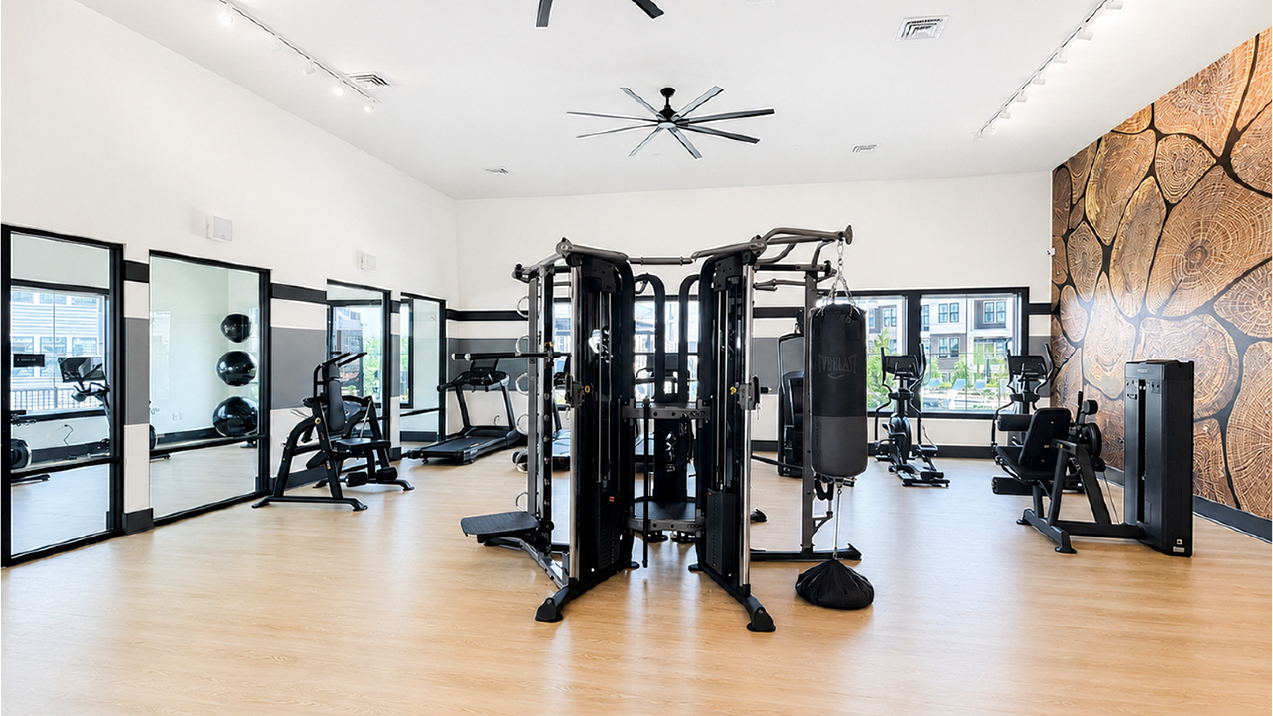 Modern fitness center with state-of-the-art equipment, mirrored walls, and stylish decor for an invigorating workout experience.