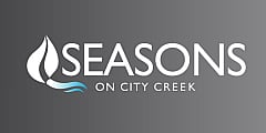 Elegant Seasons on City Creek logo featuring stylized leaf and wave on a sleek gray background.