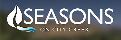 Logo for Seasons on City Creek featuring a sleek, modern leaf design against a blurred nature background.