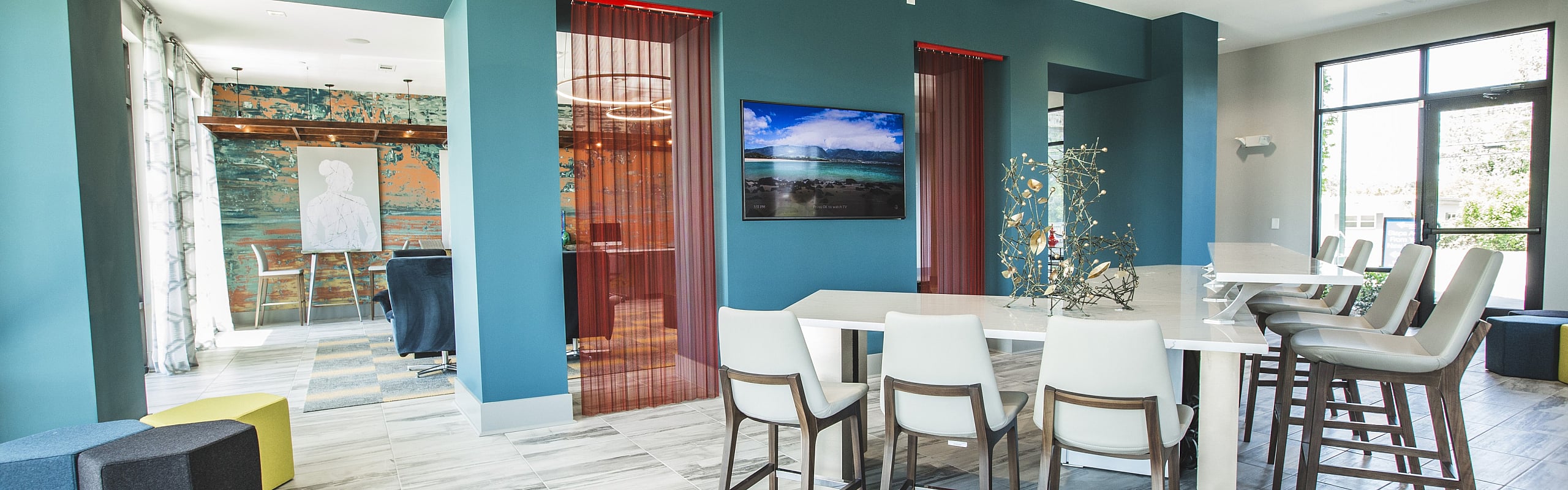 Chic open-plan living and dining area with stylish decor, modern furniture, and vibrant wall art, perfect for entertaining.