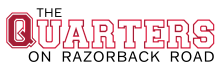 Vibrant logo of The Quarters on Razorback Road in bold red and black typography.