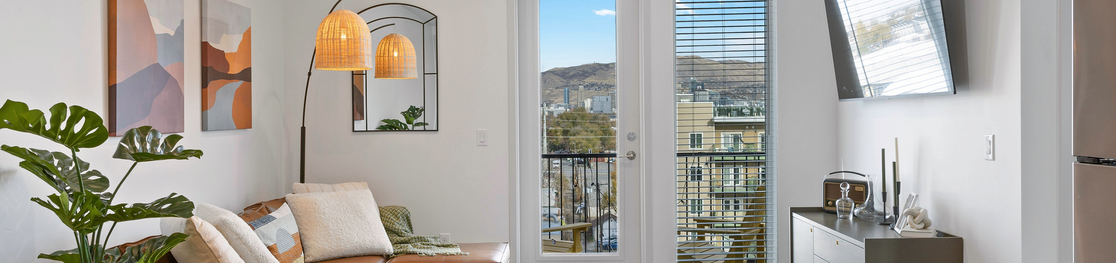 Apartment living room with balcony doors and natural light at Tradition Pointe