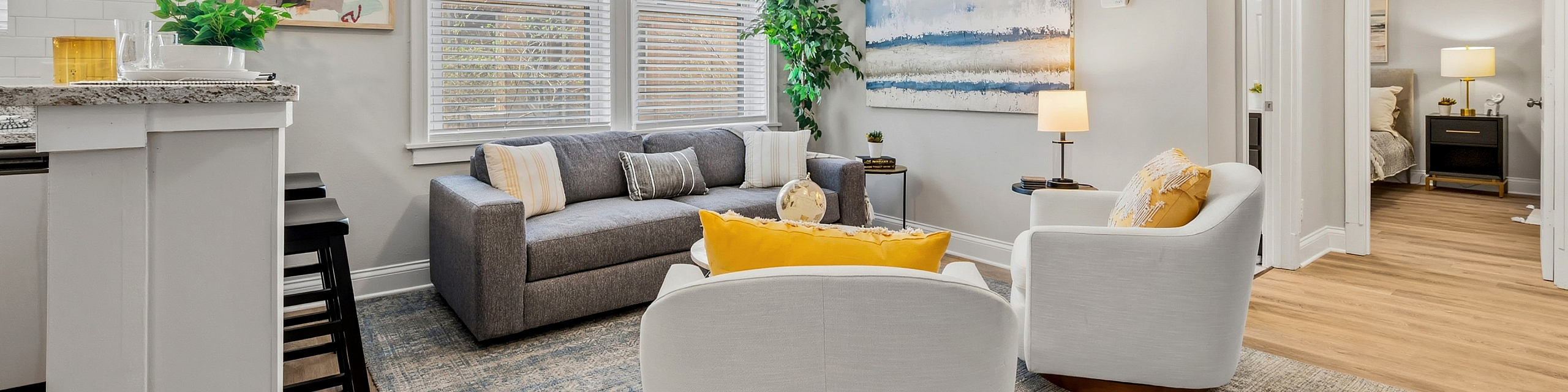 Bright and inviting living room featuring modern furniture, natural light flooding through large windows, and elegant decor.