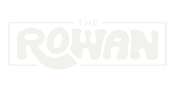 Bold and stylish logo for 'The Rowan' featuring modern typography with a playful design.