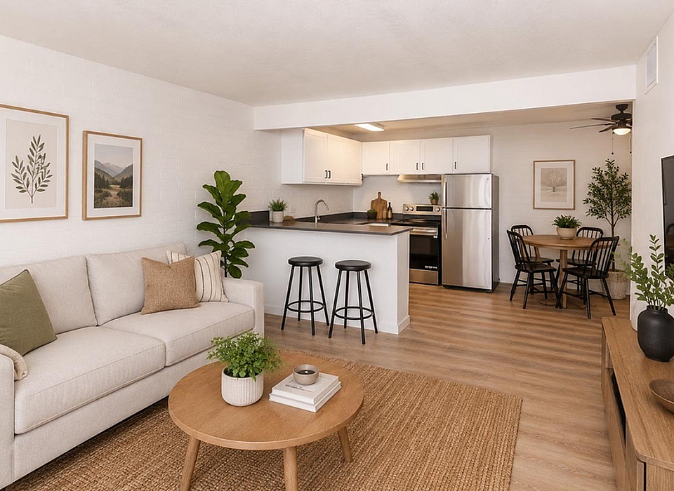 Contemporary open-plan living space featuring a cozy sofa, modern kitchen, and inviting dining area with stylish decor.