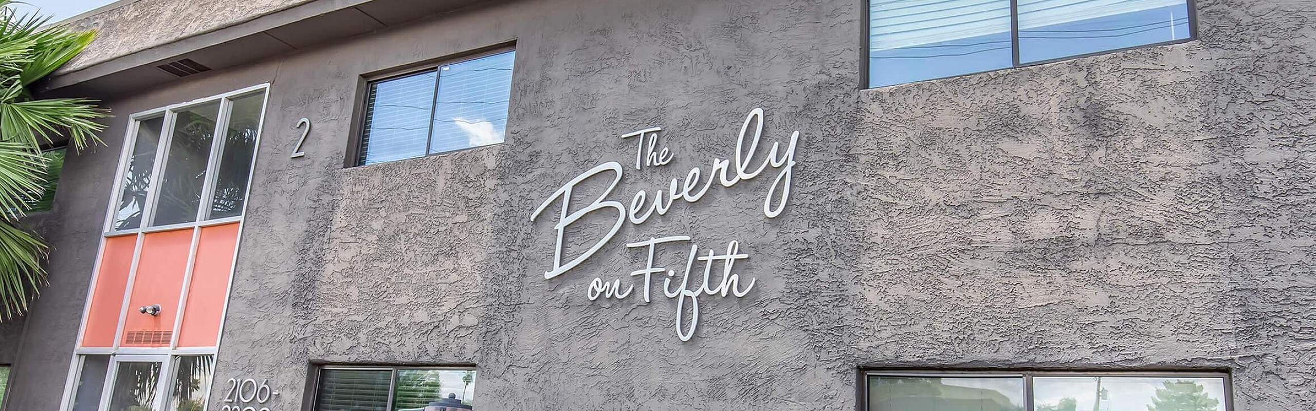 Charming exterior of The Beverly on Fifth featuring modern architecture and lush greenery.