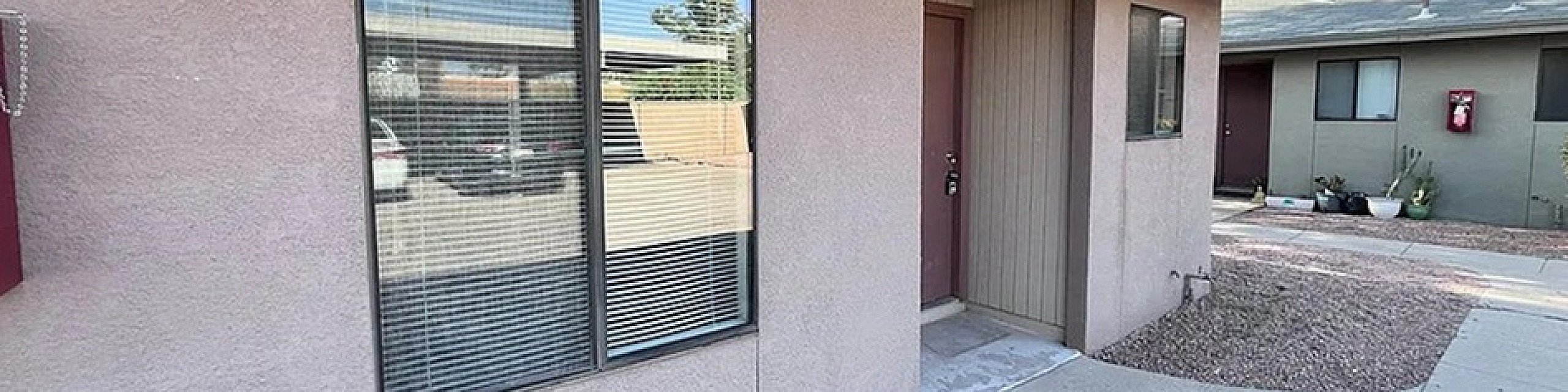 Charming single-story apartment exterior with modern windows and inviting entryway, surrounded by stylish landscaping in a serene community.