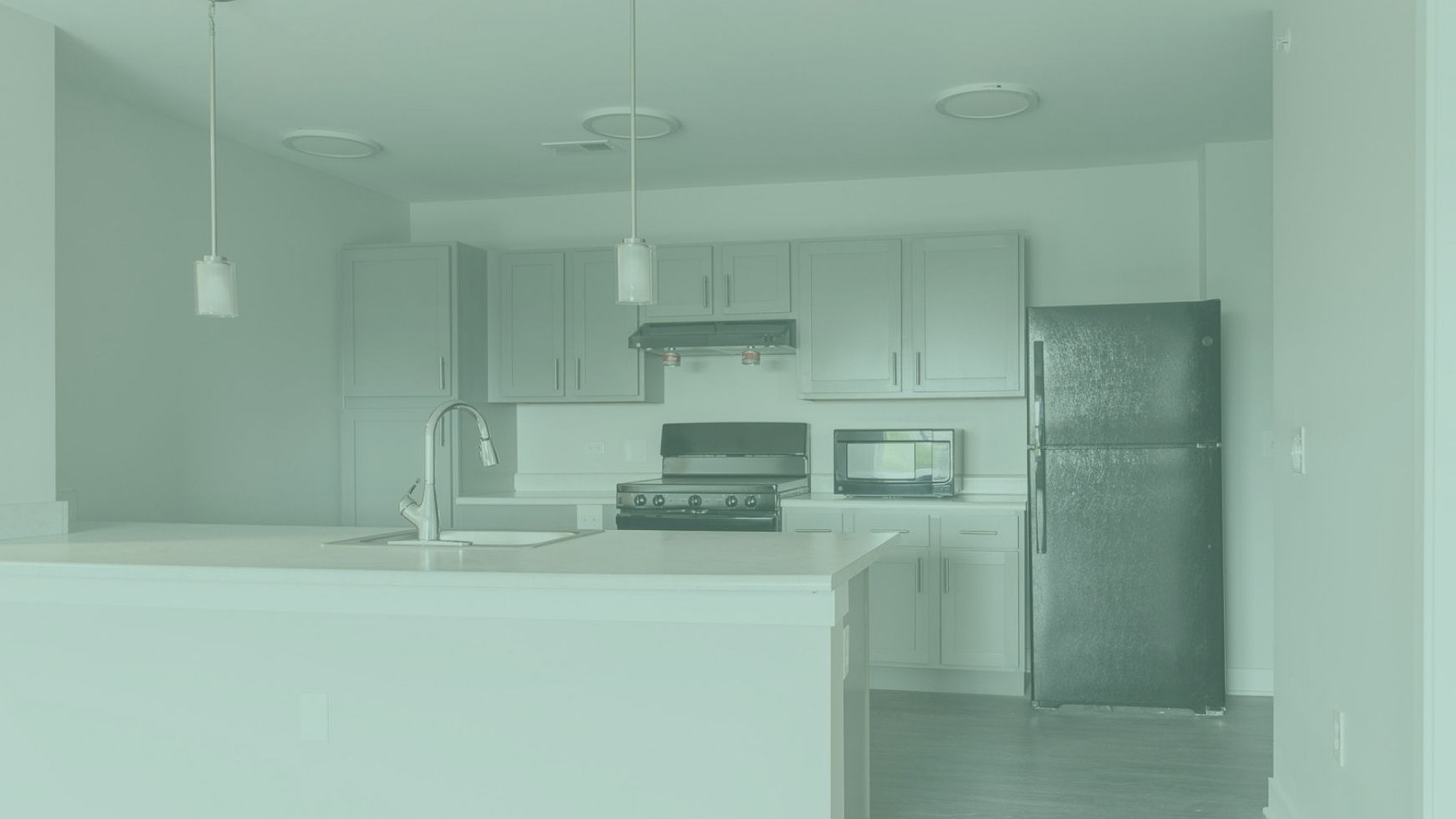 Modern kitchen design with sleek cabinetry, elegant pendant lighting, and stainless steel appliances.