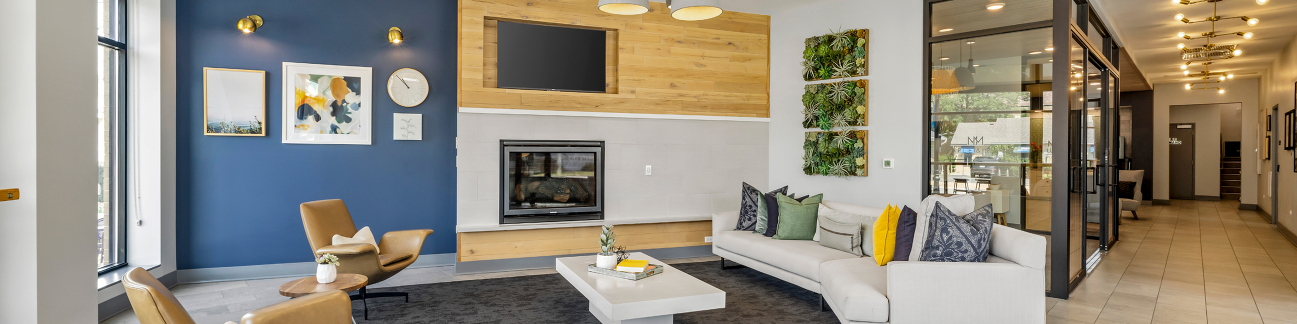 Contemporary lobby with stylish seating, modern fireplace, and vibrant wall art creating a welcoming atmosphere.