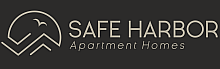 Elegant Safe Harbor Apartment Homes logo with a minimalist bird and mountain design on a sleek dark background.