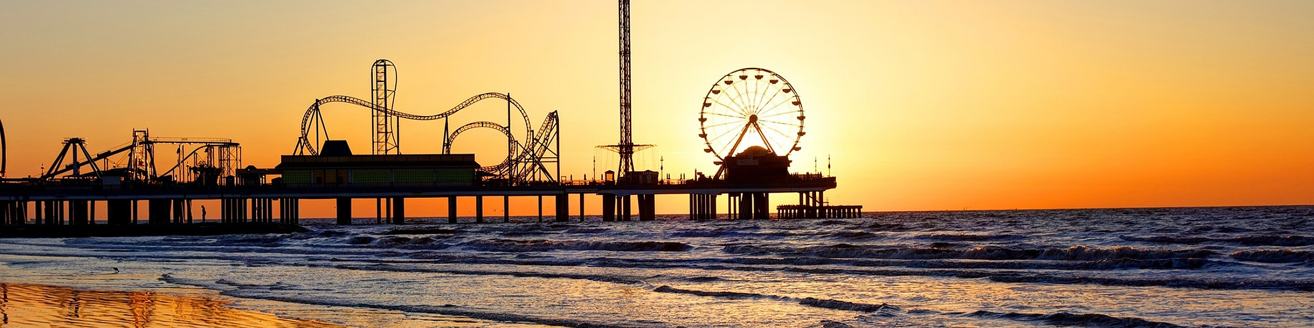 Lakside at campeche view of the galveston seawall at sunset with aa view of the pier and the theme park