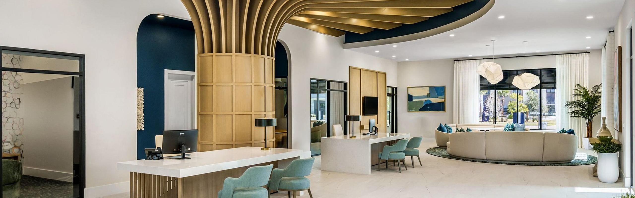 Luxurious and modern apartment lobby with stylish blue and gold decor, featuring elegant seating areas and striking architectural design.
