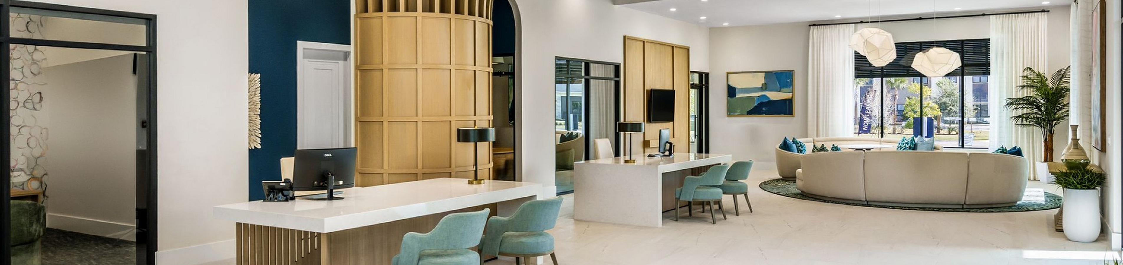Luxurious apartment lobby with modern design, featuring elegant blue and gold accents, stylish seating, and spacious layout.