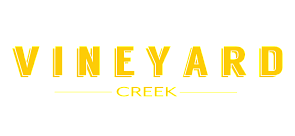 Modern and vibrant Vineyard Creek logo in bold yellow font on a clean white background.