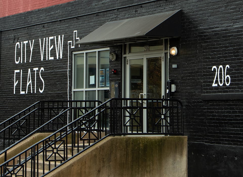 Chic urban apartment exterior with bold brickwork, featuring large windows at City View Flats.