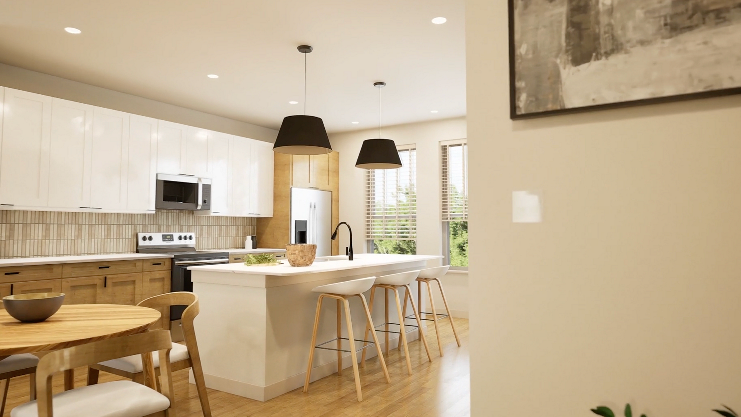 Modern kitchen with sleek white cabinets, wooden accents, elegant island with bar stools, and cozy dining area.