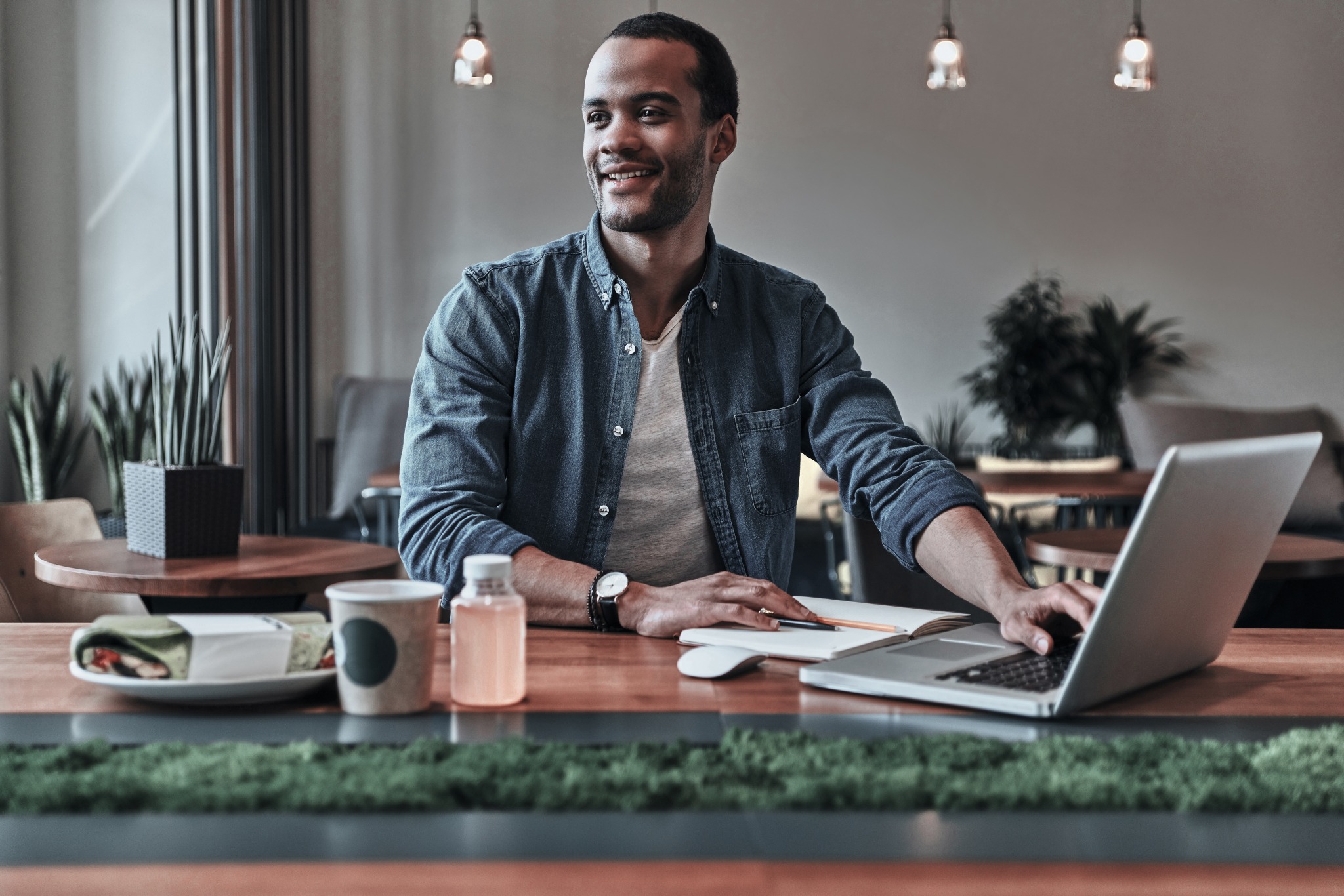 Image of internet cafe with man working