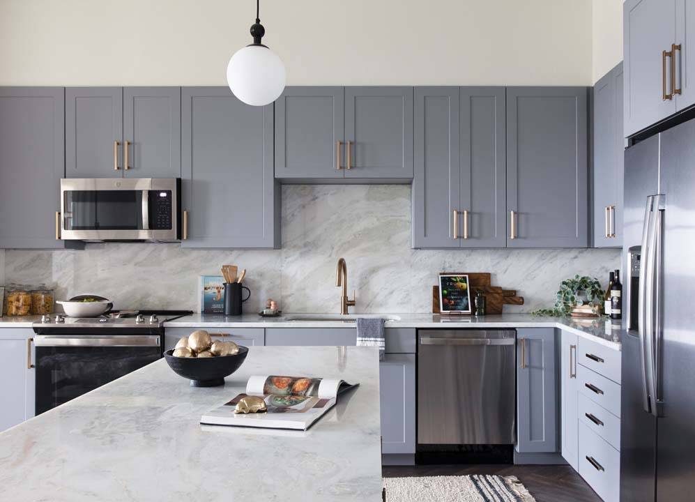 Kitchen closeup showing gray cabinets and bronze hardware