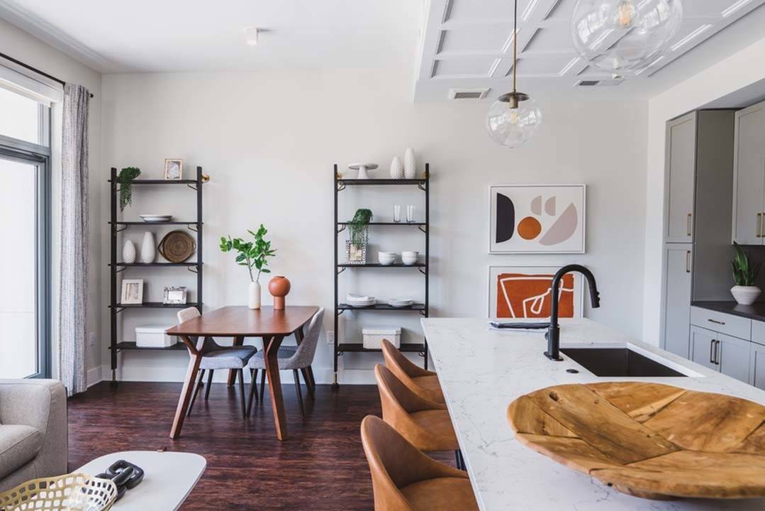 Living room with modern shelving and large kitchen island