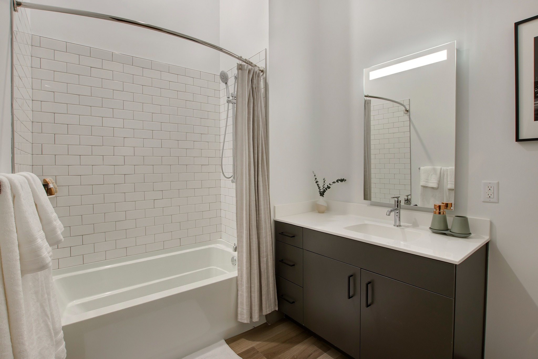 serene bathrooms with lit mirrors and tile at modera berkeley heights apartments new jersey