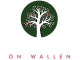 Logo of The Orchard on Wallen featuring a vibrant white tree with red apples on a dark green background, evoking a sense of community and natural beauty.
