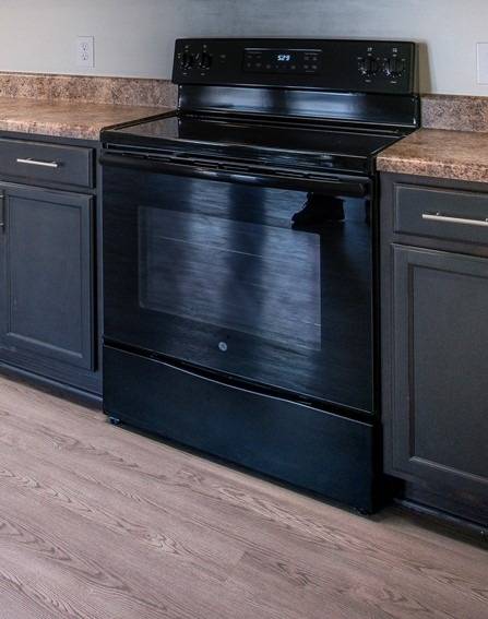 Kitchen w/Black Appliances Featuring Stove