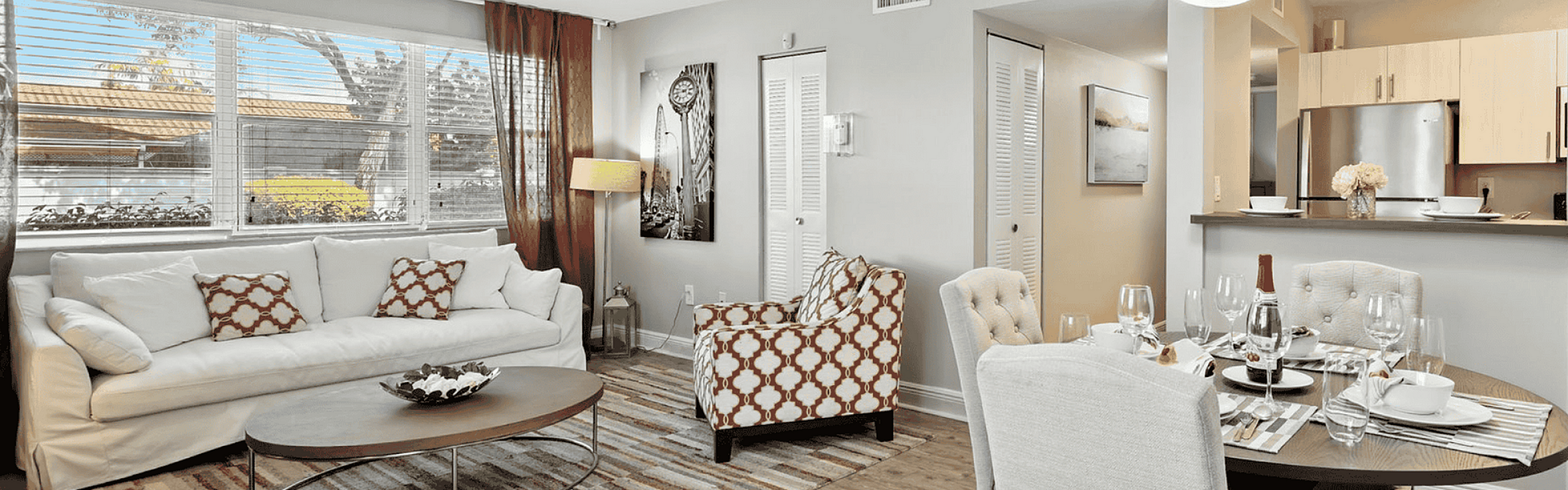 Inviting living and dining area with natural light, featuring elegant decor and an open-concept kitchen, ideal for entertaining.