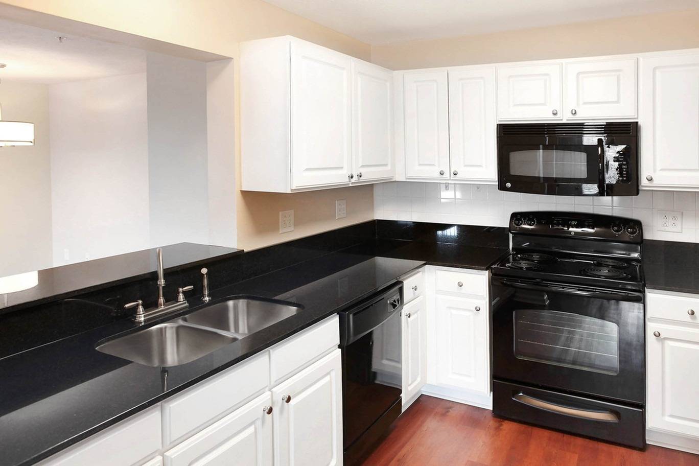 Modern Kitchen with white cabinetry and black appliances and countertops  | Wabash Landing | Apartments in West Lafayette