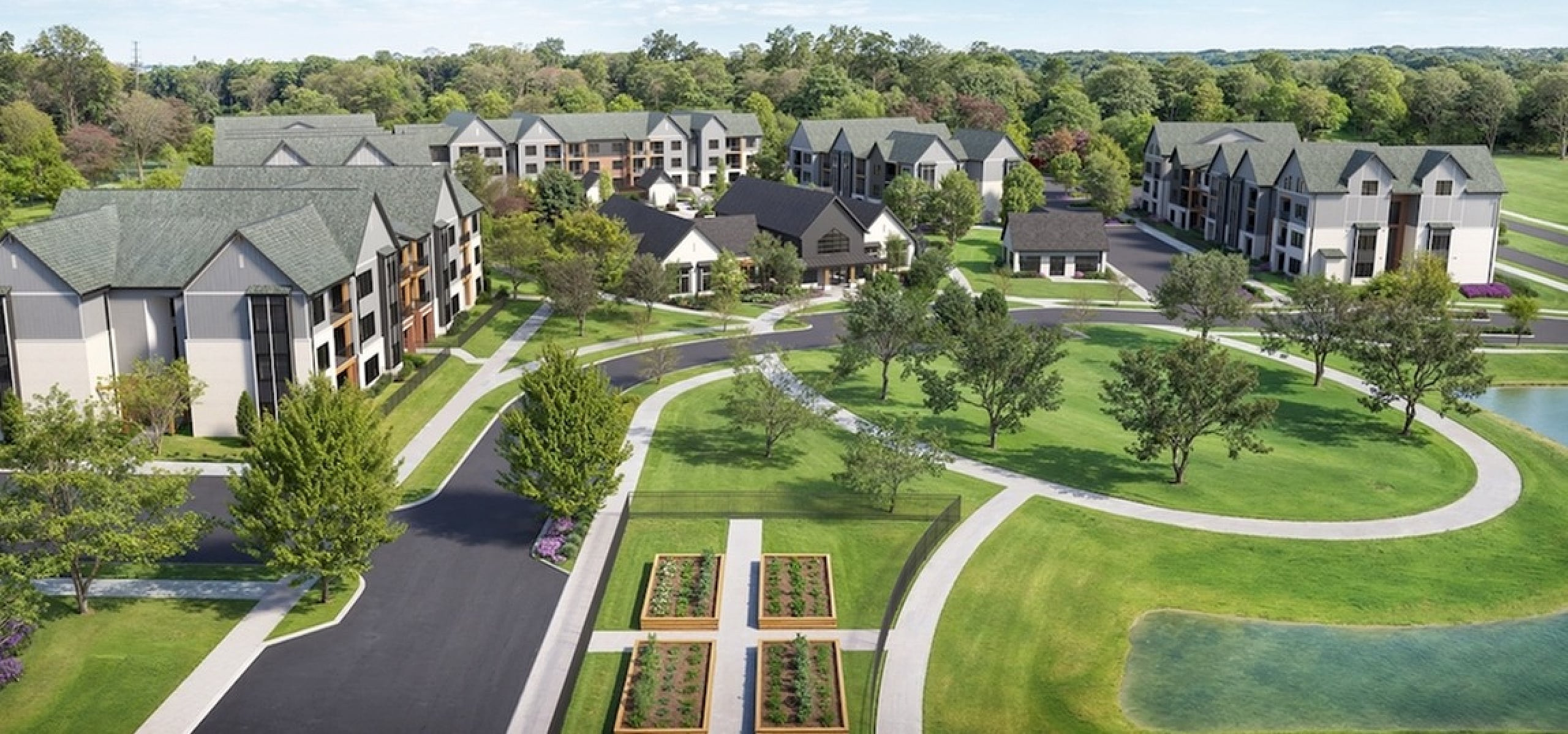 Aerial view of a serene apartment community surrounded by lush greenery and landscaped gardens.