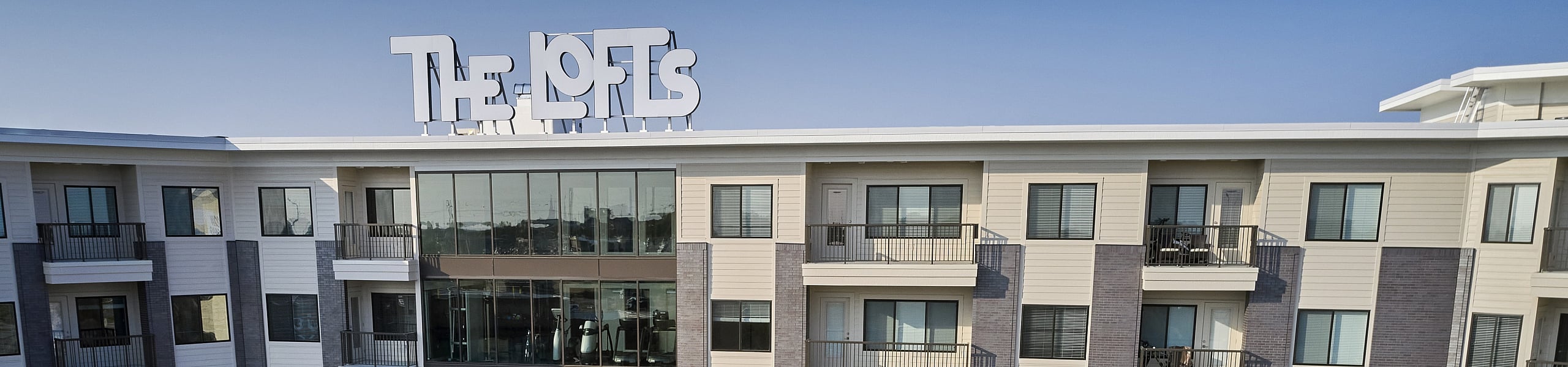 he Lofts at City Center exterior with rooftop signage and private balconies