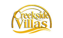 Elegant Creekside Villas logo featuring sophisticated golden typography and artistic swooshes.