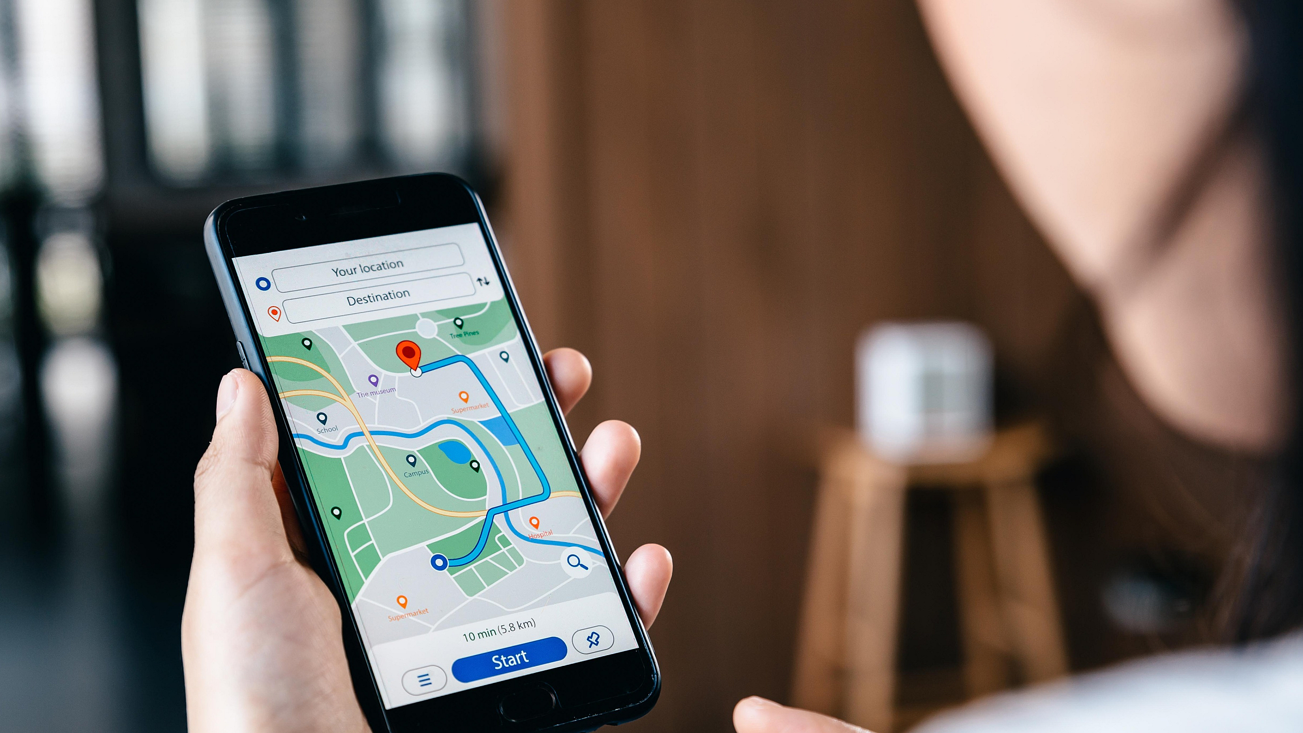 Person using smartphone with navigation app showing a clear path and destinations mapped out.