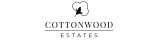 Elegant Cottonwood Estates logo featuring a stylized cotton plant design.