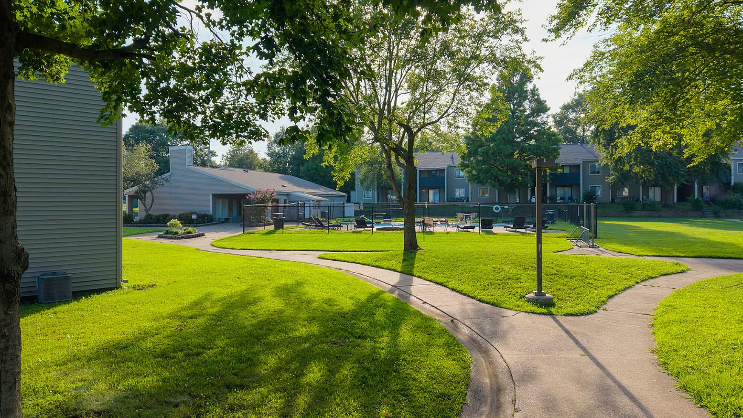 Charming apartment complex with lush greenery, winding walkways, and inviting outdoor areas perfect for enjoying nature.