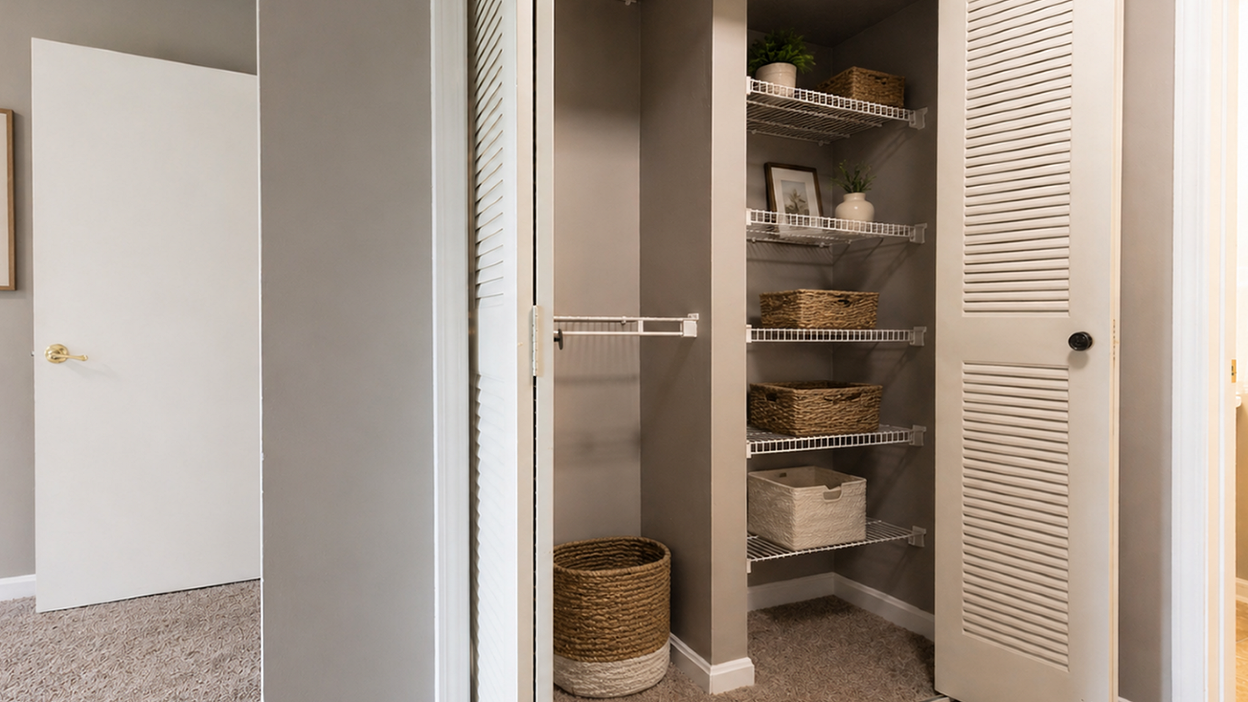 Modern closet space with stylish shelving and storage baskets, set against elegant neutral walls, enhancing a spacious bedroom feel.
